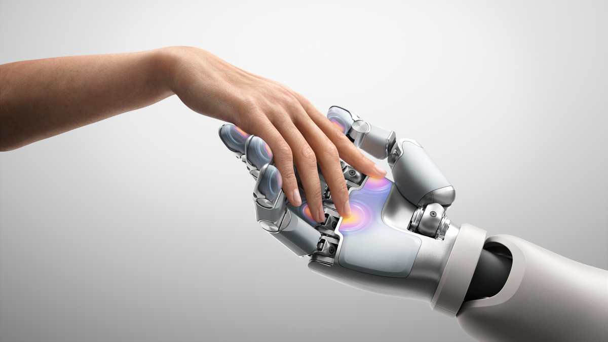 A human hand reaching toward a tactile robotic hand